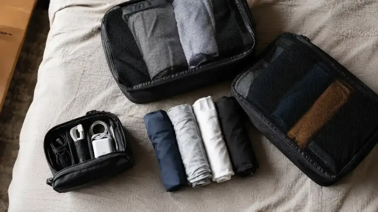 Open suitcase fully packed with organized packing cubes ready for travel